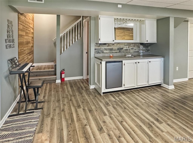 360 David Dr, Washington, MO 63090 - indoor bar featuring stairs, light wood-style flooring, and backsplash