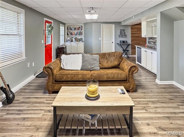 360 David Dr, Washington, MO 63090 - living room with wood finished floors, a paneled ceiling, and built in shelves