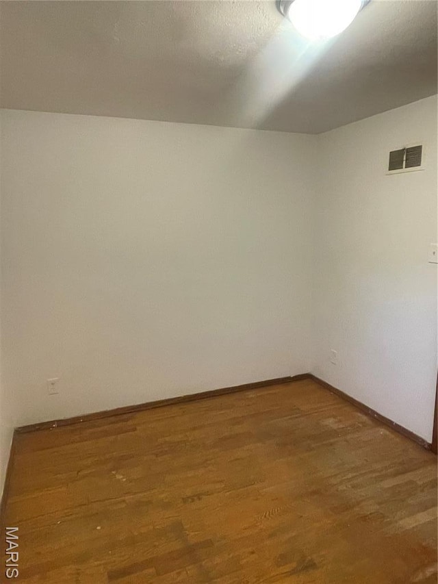 2010-12 E Desoto Ave, Saint Louis, MO 63107 - spare room with wood finished floors and baseboards
