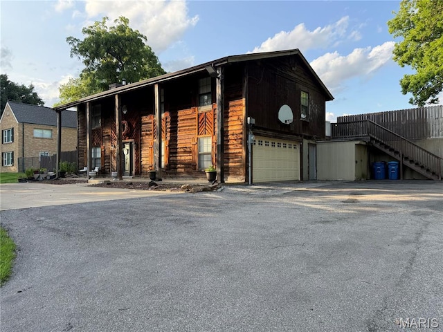10755 Kennerly Rd, Sunset Hills, MO 63128 - multi unit property with asphalt driveway, an attached garage, and stairway