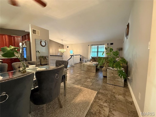 10755 Kennerly Rd, Sunset Hills, MO 63128 - dining room featuring stone tile floors, a chandelier, and vaulted ceiling