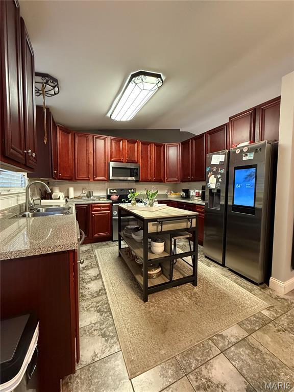 10755 Kennerly Rd, Sunset Hills, MO 63128 - kitchen featuring stainless steel appliances, dark brown cabinets, and light stone countertops