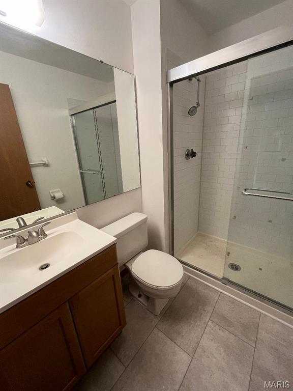 7519 Triwoods Dr Unit J, Shrewsbury, MO 63119 - bathroom with a stall shower, vanity, and tile patterned floors