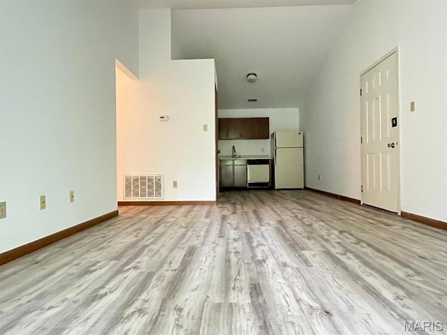 7519 Triwoods Dr Unit J, Shrewsbury, MO 63119 - unfurnished living room with light wood finished floors and baseboards