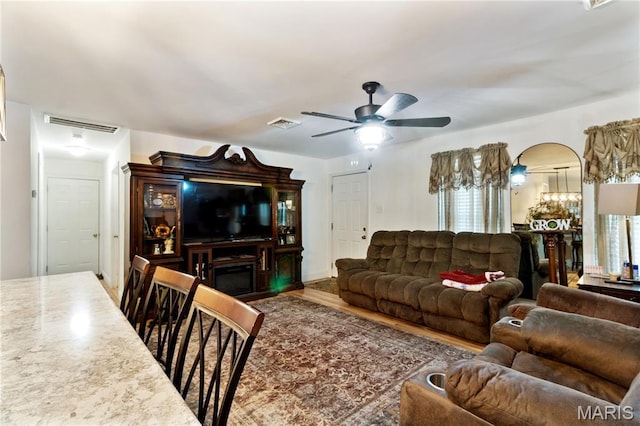 407 N 11th St, De Soto, MO 63020 - living room featuring a ceiling fan, arched walkways, wood finished floors, and plenty of natural light