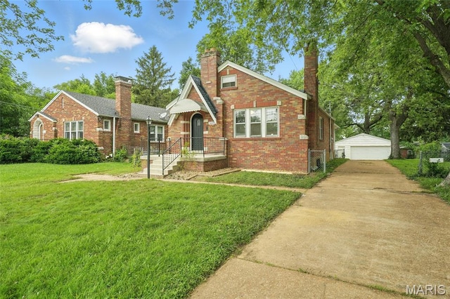 8609 Engler Ave, Saint Louis, MO 63114 - english style home with brick siding, a front lawn, a detached garage, and an outdoor structure
