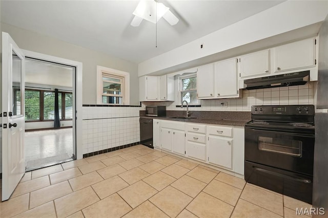 8609 Engler Ave, Saint Louis, MO 63114 - kitchen with black appliances, dark countertops, white cabinets, under cabinet range hood, and a ceiling fan