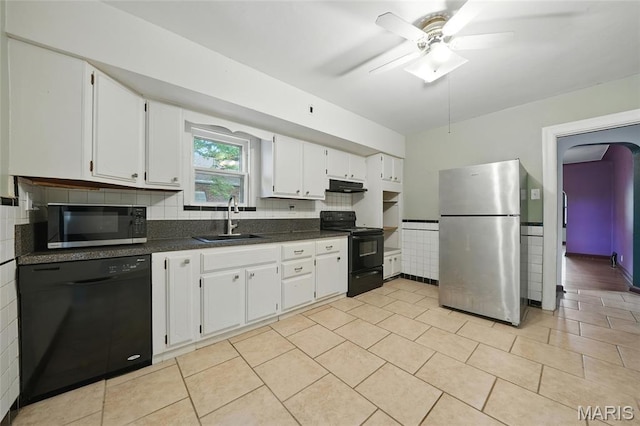 8609 Engler Ave, Saint Louis, MO 63114 - kitchen with black appliances, dark countertops, under cabinet range hood, and white cabinetry