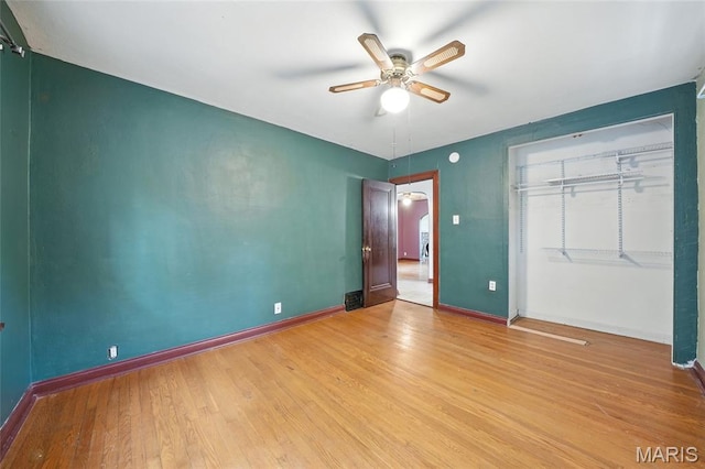 8609 Engler Ave, Saint Louis, MO 63114 - unfurnished bedroom with light wood finished floors, a closet, ceiling fan, and arched walkways