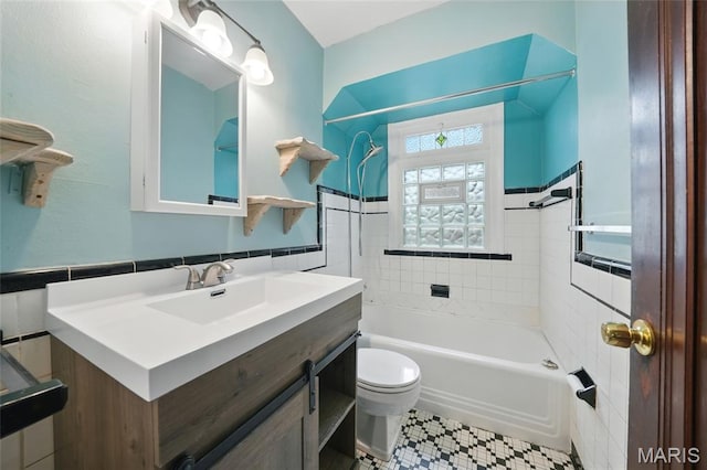 8609 Engler Ave, Saint Louis, MO 63114 - bathroom featuring tile walls, bathing tub / shower combination, vanity, and wainscoting
