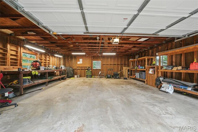 8609 Engler Ave, Saint Louis, MO 63114 - garage featuring a workshop area and a garage door opener