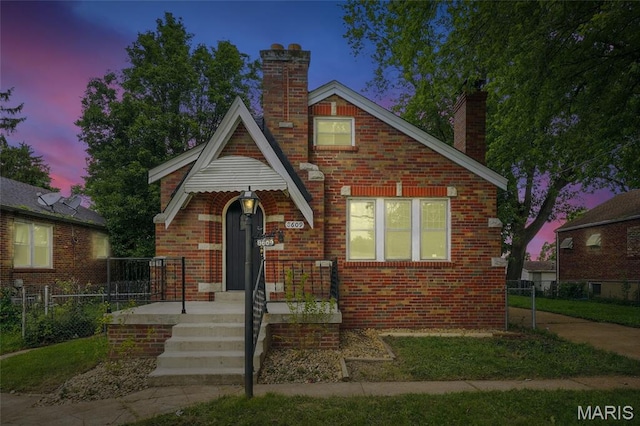 8609 Engler Ave, Saint Louis, MO 63114 - tudor house with a chimney and brick siding