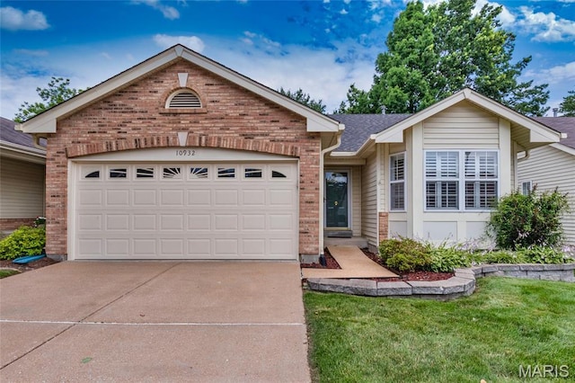 10932 Concord Circle Dr, Concord Village, MO 63123 - single story home featuring brick siding, concrete driveway, an attached garage, and a front lawn