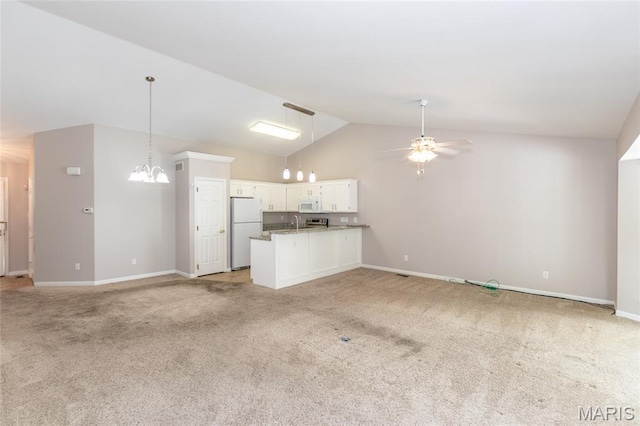 10932 Concord Circle Dr, Concord Village, MO 63123 - unfurnished living room featuring light carpet, lofted ceiling, a ceiling fan, and a chandelier