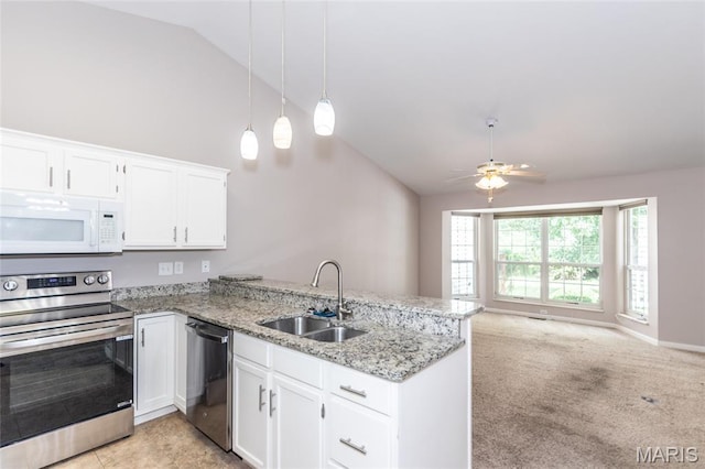 10932 Concord Circle Dr, Concord Village, MO 63123 - kitchen featuring stainless steel appliances, a peninsula, white cabinets, open floor plan, and high vaulted ceiling