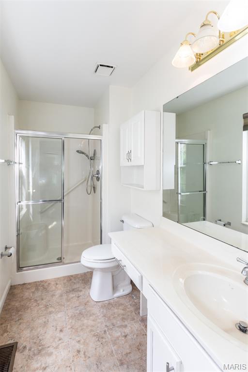 10932 Concord Circle Dr, Concord Village, MO 63123 - full bathroom featuring vanity and a shower stall