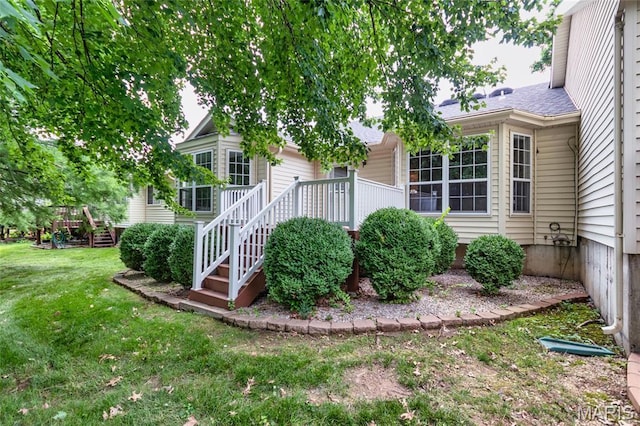 10932 Concord Circle Dr, Concord Village, MO 63123 - view of front facade featuring a front lawn, stairway, and a wooden deck