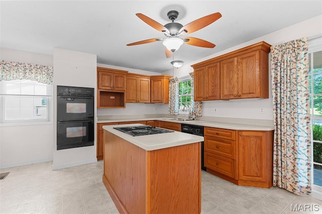 11894 Featherwood Dr, Creve Coeur Township, MO 63146 - kitchen with black appliances, light countertops, ceiling fan, a kitchen island, and brown cabinets