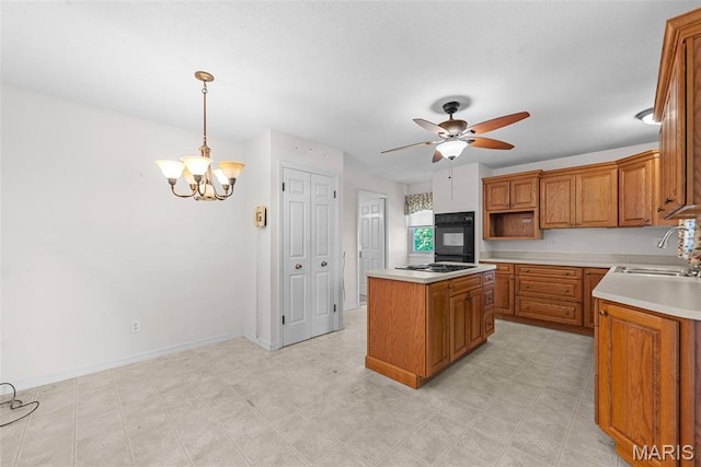 11894 Featherwood Dr, Creve Coeur Township, MO 63146 - kitchen featuring oven, cooktop, a center island, ceiling fan, and light countertops