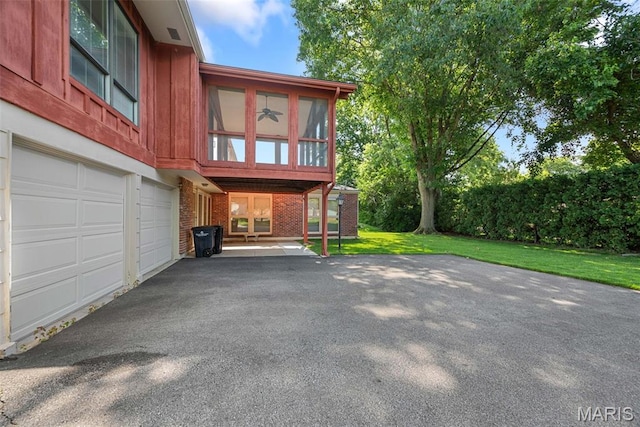 11894 Featherwood Dr, Creve Coeur Township, MO 63146 - back of property featuring brick siding, driveway, a lawn, and board and batten siding