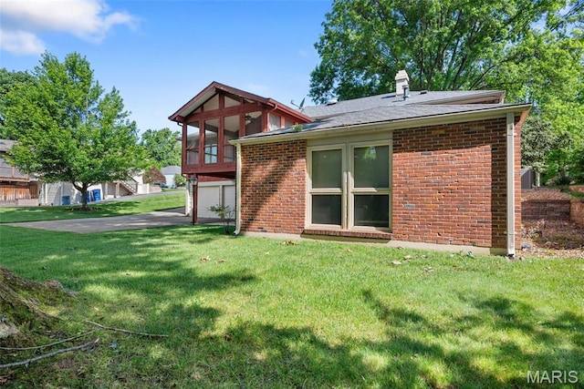 11894 Featherwood Dr, Creve Coeur Township, MO 63146 - back of property featuring a sunroom, brick siding, a chimney, and a garage