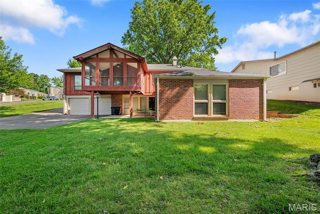 11894 Featherwood Dr, Creve Coeur Township, MO 63146 - view of front of house featuring a garage, asphalt driveway, a front lawn, a sunroom, and brick siding