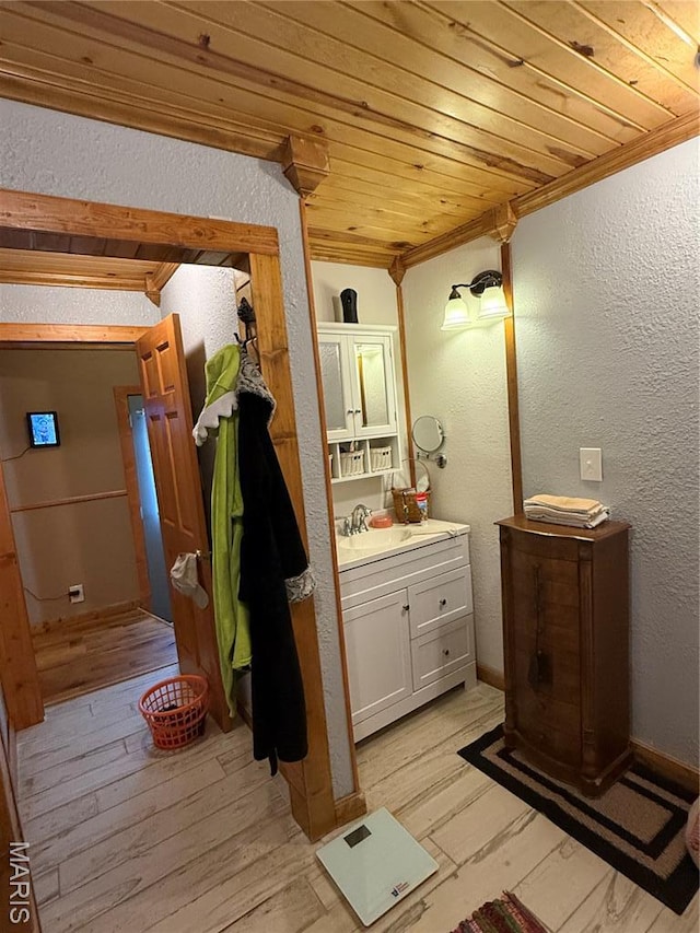 32 E 4th St, Gerald, MO 63037 - bathroom with a textured wall, wooden ceiling, vanity, crown molding, and wood finished floors