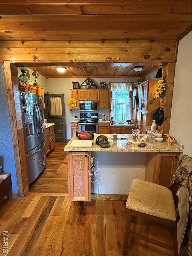 32 E 4th St, Gerald, MO 63037 - kitchen featuring appliances with stainless steel finishes, brown cabinetry, a peninsula, dark wood-style floors, and wooden ceiling