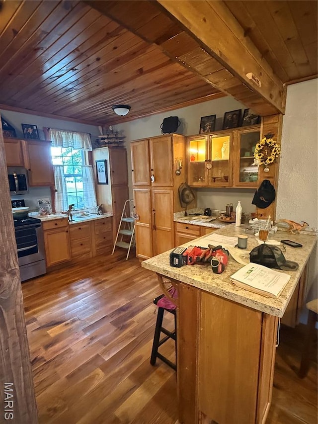 32 E 4th St, Gerald, MO 63037 - kitchen featuring stainless steel appliances, wooden ceiling, dark wood-style flooring, a breakfast bar area, and glass insert cabinets