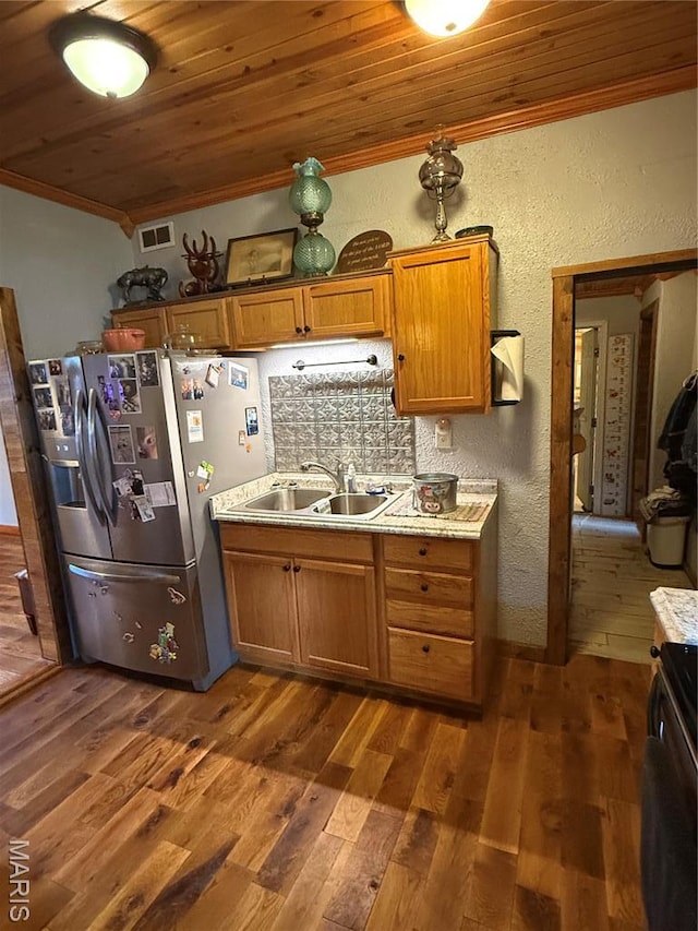 32 E 4th St, Gerald, MO 63037 - kitchen featuring stainless steel fridge, ornamental molding, wooden ceiling, brown cabinetry, and light countertops
