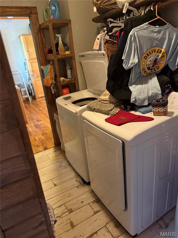 32 E 4th St, Gerald, MO 63037 - laundry area with washer and clothes dryer and light wood-type flooring
