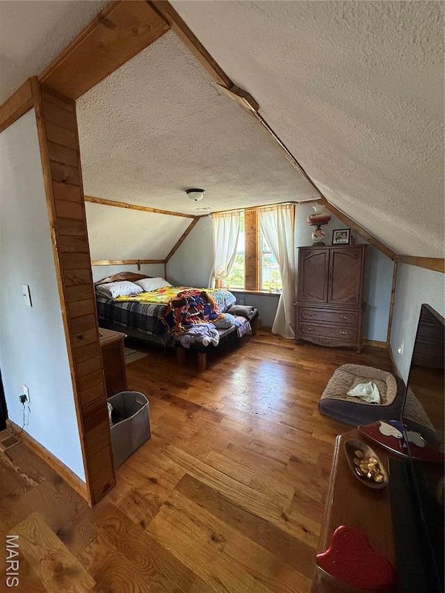 32 E 4th St, Gerald, MO 63037 - bedroom featuring a textured ceiling, vaulted ceiling, and wood finished floors