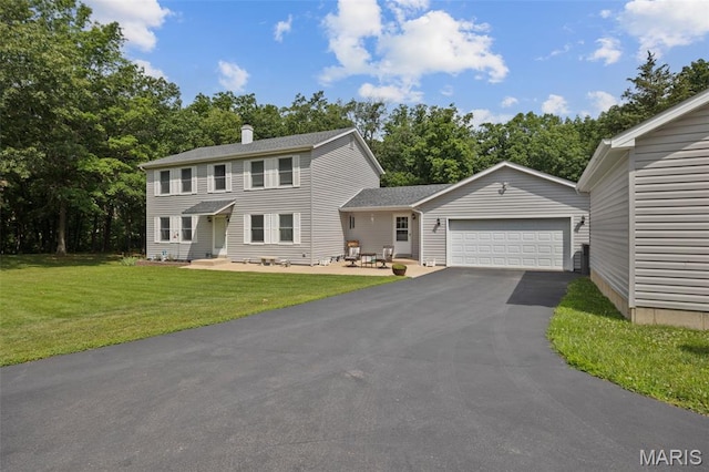 6235 Meadowlark Ln, Troy, MO 63379 - colonial inspired home with a garage, driveway, a front yard, a chimney, and view of wooded area
