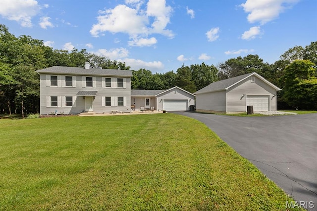 6235 Meadowlark Ln, Troy, MO 63379 - colonial-style house with an outdoor structure, a front lawn, view of wooded area, and a chimney