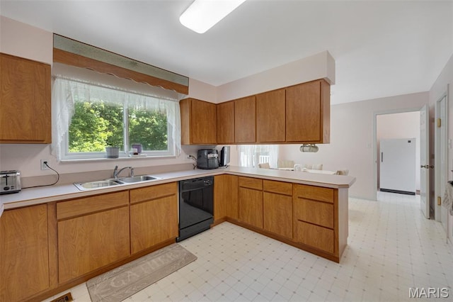 6235 Meadowlark Ln, Troy, MO 63379 - kitchen with dishwasher, light countertops, light floors, a peninsula, and brown cabinets