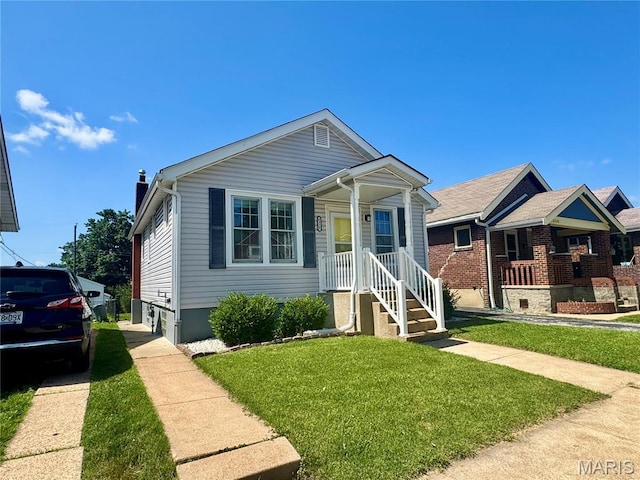 6328 Bradley Ave, Saint Louis, MO 63139 - view of front facade featuring a front lawn and a chimney