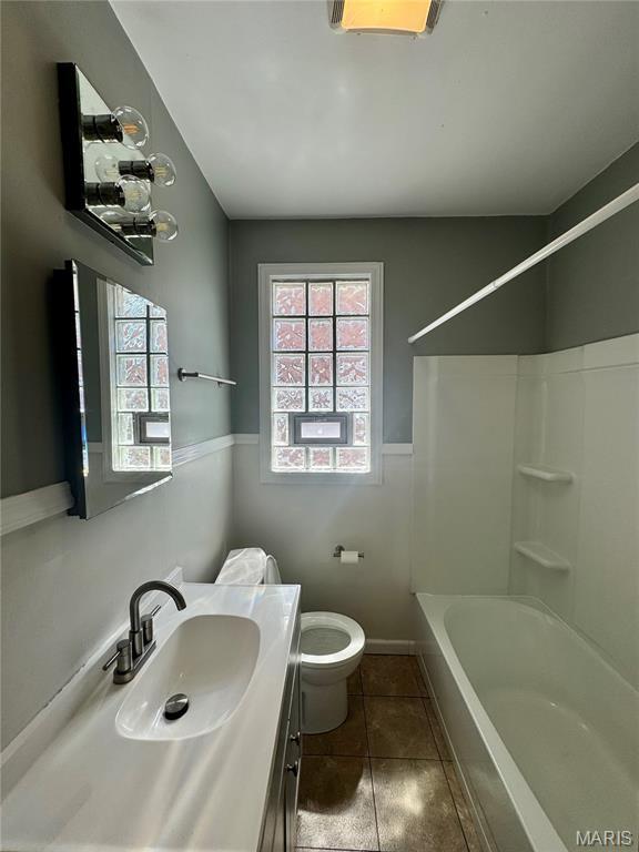 6328 Bradley Ave, Saint Louis, MO 63139 - full bath featuring vanity, healthy amount of natural light, tub / shower combination, and tile patterned flooring