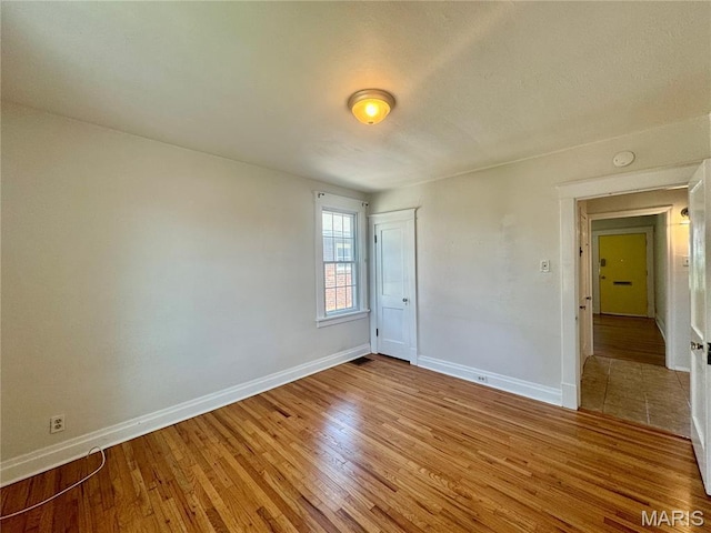 6328 Bradley Ave, Saint Louis, MO 63139 - spare room with light wood-type flooring and a smoke detector