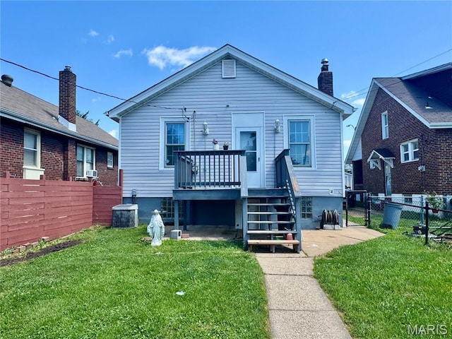 6328 Bradley Ave, Saint Louis, MO 63139 - rear view of house with a deck, a fenced backyard, and a chimney