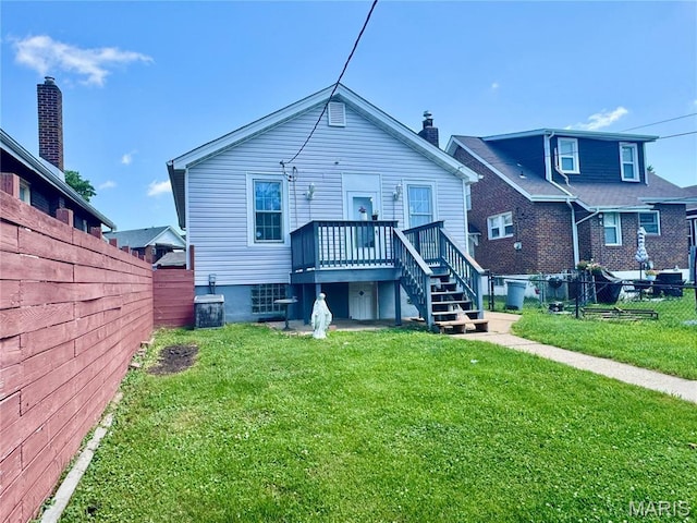 6328 Bradley Ave, Saint Louis, MO 63139 - rear view of house featuring a fenced backyard, a wooden deck, and stairway