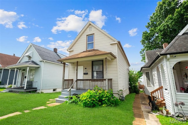 4340 Gannett St, Saint Louis, MO 63116 - view of front of home featuring a porch and a front yard