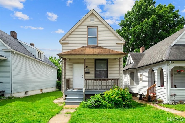 4340 Gannett St, Saint Louis, MO 63116 - view of front of house with covered porch and a front lawn