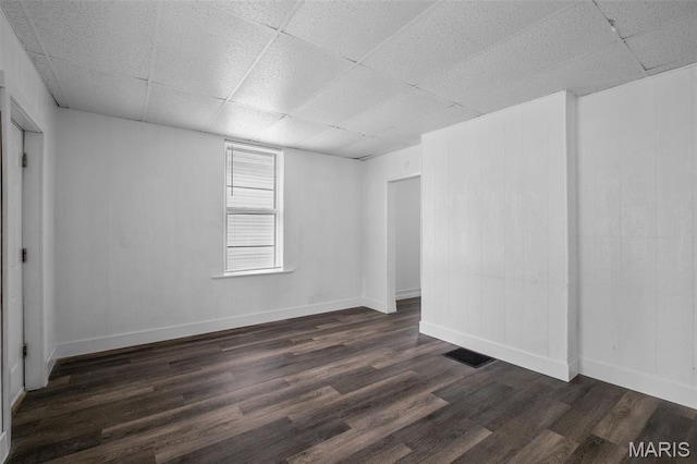 4340 Gannett St, Saint Louis, MO 63116 - empty room with a paneled ceiling and dark wood-type flooring