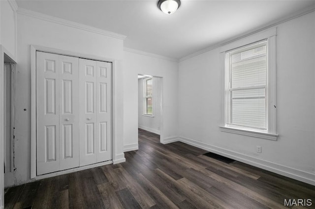 4340 Gannett St, Saint Louis, MO 63116 - unfurnished bedroom featuring dark wood-style flooring, ornamental molding, and a closet