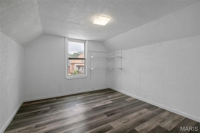 4340 Gannett St, Saint Louis, MO 63116 - bonus room featuring a textured ceiling, dark wood-type flooring, lofted ceiling, and a textured wall