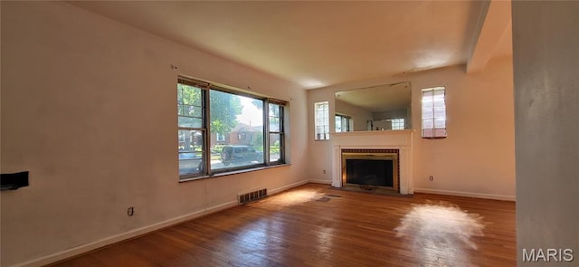 5464 Lindenwood Ave, Saint Louis, MO 63109 - unfurnished living room featuring wood finished floors and a fireplace with flush hearth