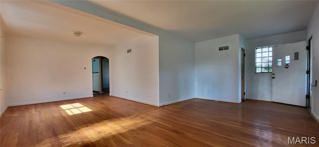 5464 Lindenwood Ave, Saint Louis, MO 63109 - unfurnished room featuring arched walkways and wood finished floors
