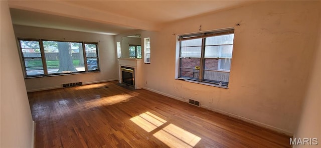 5464 Lindenwood Ave, Saint Louis, MO 63109 - unfurnished living room featuring wood finished floors and a glass covered fireplace