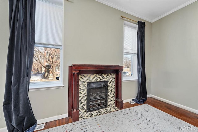 2610 Rutger St, Saint Louis, MO 63104 - living room featuring crown molding, wood finished floors, healthy amount of natural light, and a tiled fireplace