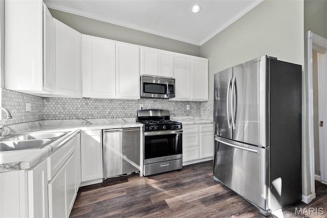 2610 Rutger St, Saint Louis, MO 63104 - kitchen with stainless steel appliances, dark wood-type flooring, crown molding, white cabinetry, and tasteful backsplash